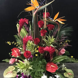 Tall tropical arrangement with red roses, anthuriums, and bird of paradise
