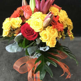 Bouquet of yellow and red roses with lilies and gerbera daisies