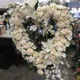 Large white floral heart wreath on an easel