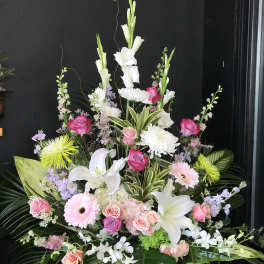 Large floral spray with white lilies, pink roses, and chrysanthemums