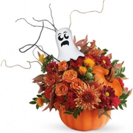 Halloween bouquet in a pumpkin container with a ghost topper