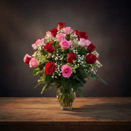 Bouquet of red and pink roses in a clear glass vase