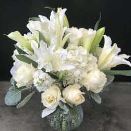 White floral bouquet in a textured glass vase