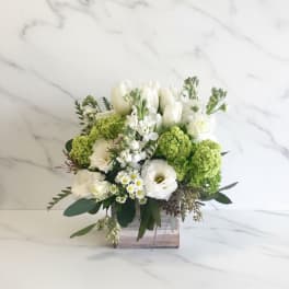 White and green floral arrangement in a wooden box