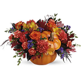 Pumpkin-shaped floral arrangement with orange and red flowers