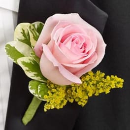 Pink rose boutonniere with variegated greenery and yellow filler