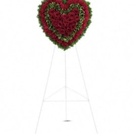Heart-shaped standing floral wreath of red roses on an easel