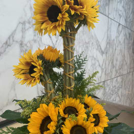 Sunflower arrangement with two tiers of blooms and greenery