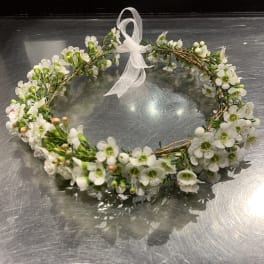 White floral wreath with a sheer ribbon bow