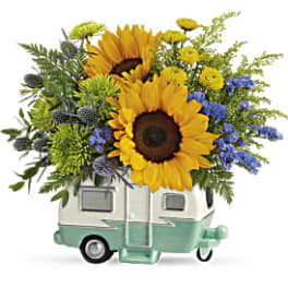 Sunflower arrangement in a small camper-shaped container