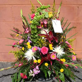 Large mixed floral arrangement with pink, yellow, and white blooms