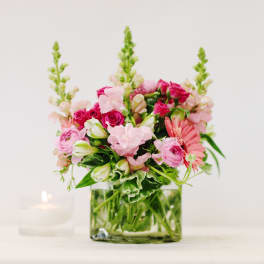 Pink mixed bouquet in a square glass vase