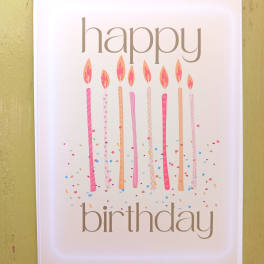 Happy birthday greeting card with tall pink candles and confetti