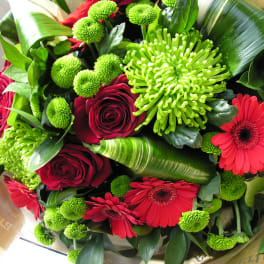 Bouquet of red roses, red gerbera daisies, and green chrysanthemums