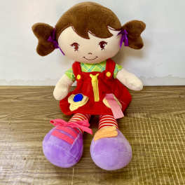 Plush doll with brown pigtails, red dress, and purple shoes