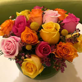Colorful bouquet of roses in a green vase