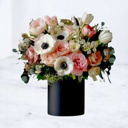 Pink and white mixed bouquet in a black vase
