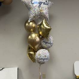 Cluster of gold and printed congratulatory balloons with a star balloon