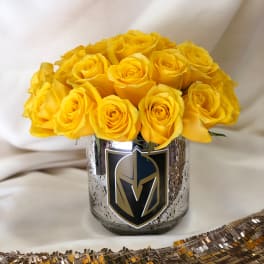 Yellow roses arranged in a metallic vase with a sports logo