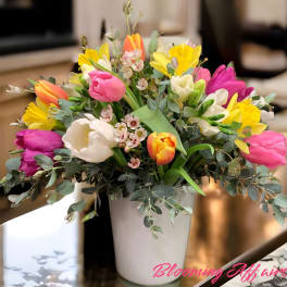 Colorful tulip bouquet in a white vase