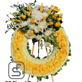 Standing yellow and white rose and mum wreath on a wooden easel