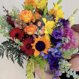 Colorful bouquet with sunflowers, roses, lilies, and gerbera daisies