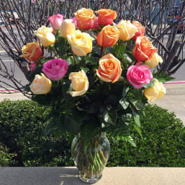 Bouquet of multicolored roses in a clear glass vase