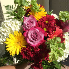 Bouquet of pink roses, yellow gerbera daisies, and red chrysanthemums