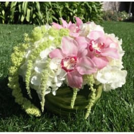 Pink orchids and white hydrangeas in a green vase