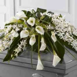 White floral spray arranged on a casket