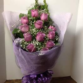 Bouquet of purple roses wrapped in lavender mesh