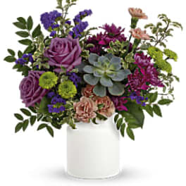 Mixed bouquet in a white vase with purple, pink, and green blooms