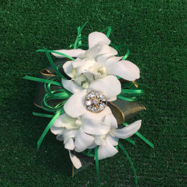 White orchid corsage with green ribbon and jeweled center