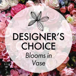 Pink and white roses behind a "Designer’s Choice Blooms in Vase" label