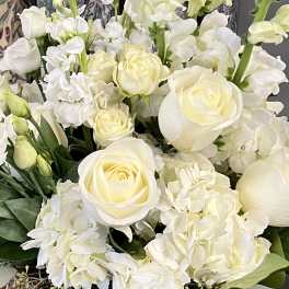 White roses and hydrangeas with pale green stock in a bouquet