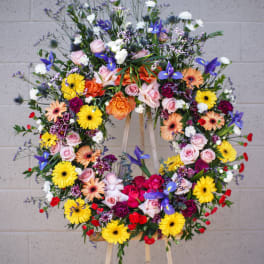 Large colorful floral wreath on a wooden easel