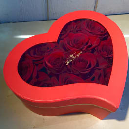 Heart-shaped red box filled with red roses