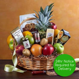Gift basket filled with assorted fresh fruits, gourmet snacks, and ribbon with 24hr delivery notice badge