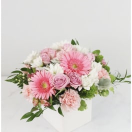 Pink and white bouquet in a white box vase
