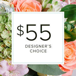 Designer’s choice floral arrangement with peach roses and mixed blooms