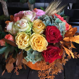 Mixed bouquet of roses in pink, yellow, red, and cream tones