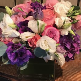 Bouquet of pink, purple, and white flowers in a black box