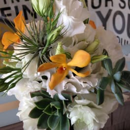Bouquet of white flowers with orange orchids and succulents
