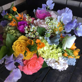 Colorful bouquet of roses, sweet peas, and mixed blooms