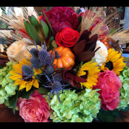 Mixed bouquet with sunflowers, roses, hydrangeas, and pumpkins
