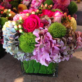 Pink and purple floral arrangement in a glass vase