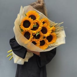 Bouquet of sunflowers wrapped in striped paper