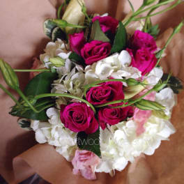 Hand-tied bouquet of hot pink roses and white hydrangeas