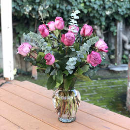Pink roses arranged in a clear glass vase