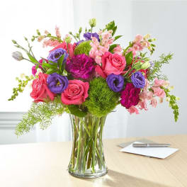 Mixed pink and purple bouquet in a clear glass vase